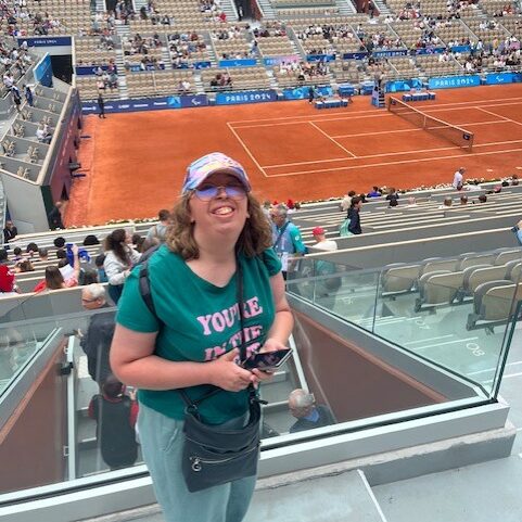 Une résidente des Résidences du Vexin pose dans les tribunes de Rolland Garros avant d'assister à un match de tennis fauteuil.